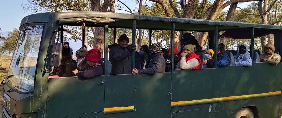 Elephant safari group crossing river in Corbett Park reserve